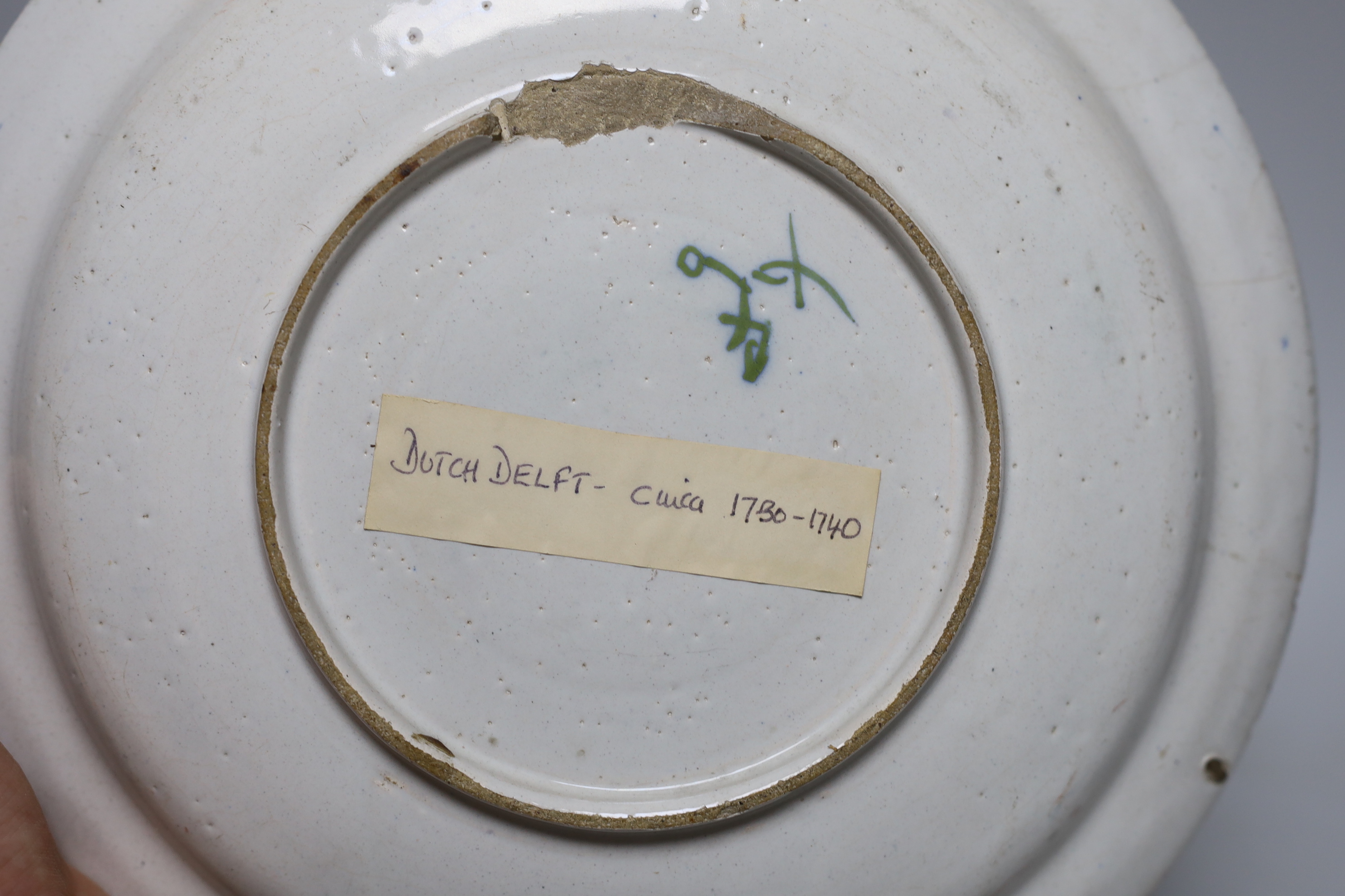 An 18th century Delft plate and three 19th century faience plates, largest 26cm diameter (4)